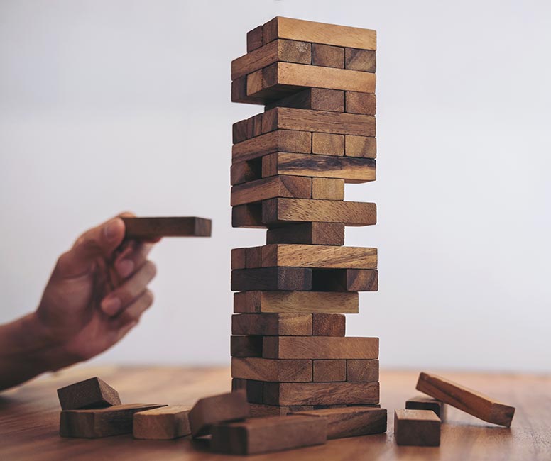 Jenga game signifying how product scraping can undermine your business